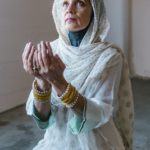 woman in white hijab praying