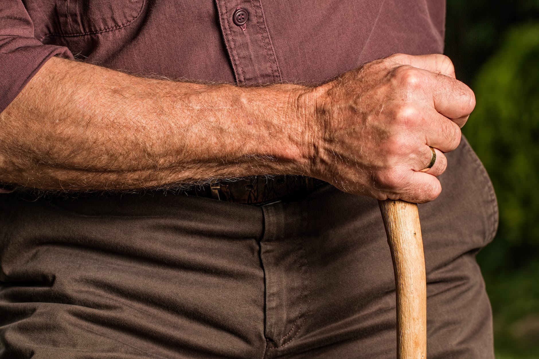 man holding wood cane