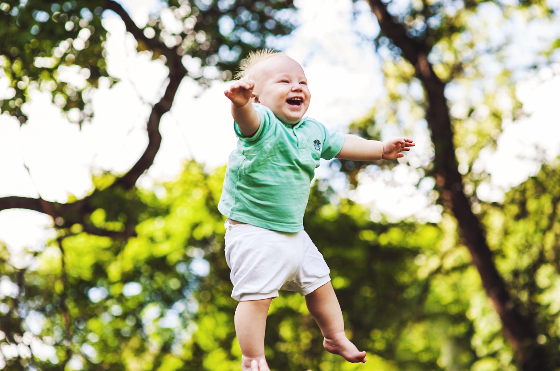 laughing baby floating on air