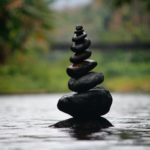 black stackable stone decor at the body of water