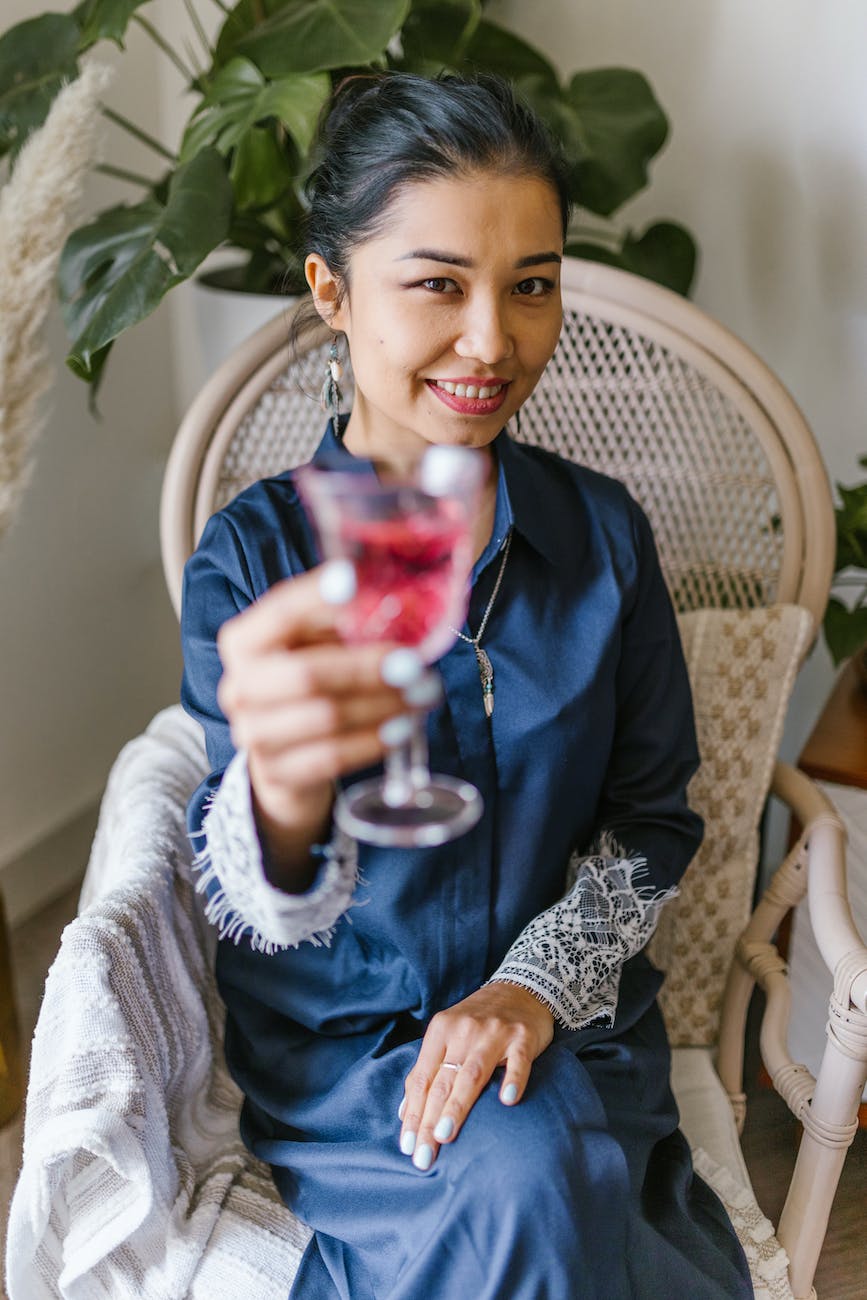 woman holding a glass with wine