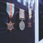 three medals in glass enclosure