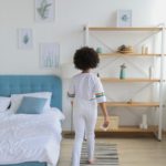 black girl in casual outfit in modern comfortable room