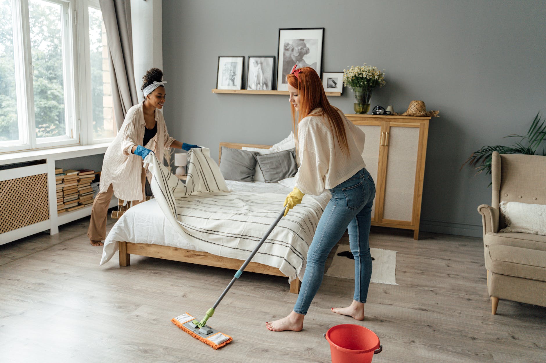 women cleaning a bedroom