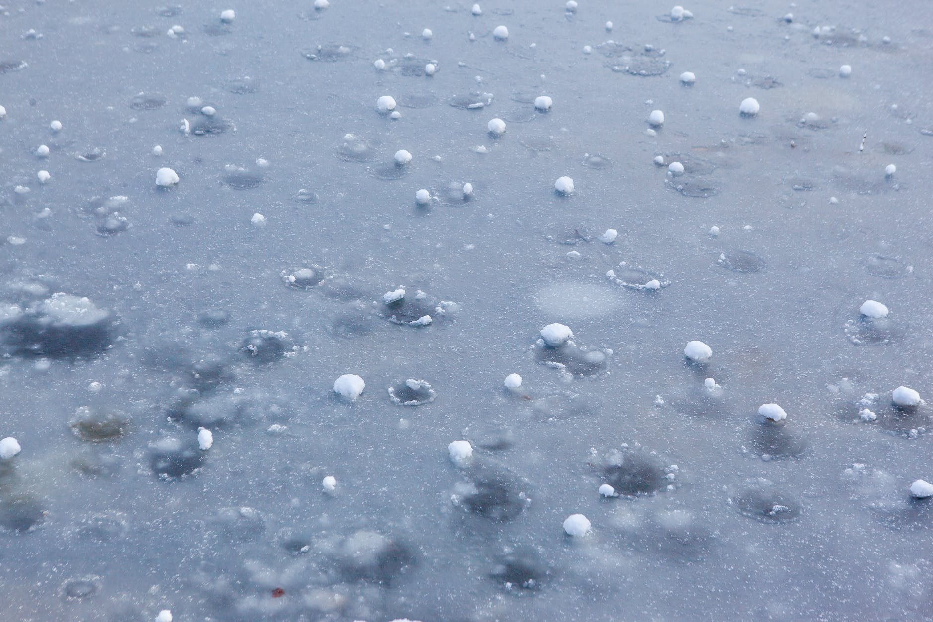 hail balls after heavy rain lying on ice