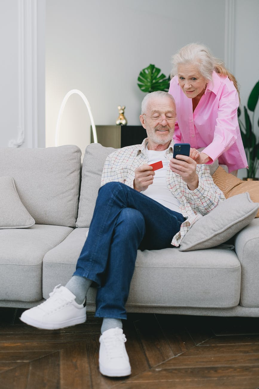 an elderly couple using a smartphone
